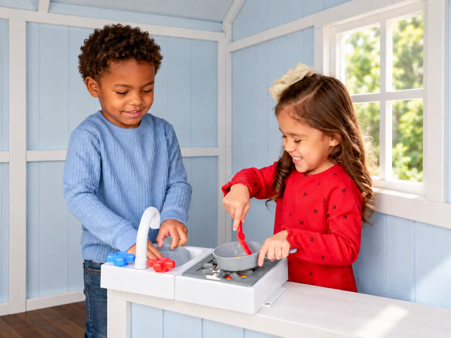 Children learning to collaborate together during kitchen play session inside a Rivelle playhouse.
